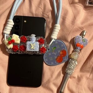 Red and Blue Phone Strap with Charm and Matching Pen Set.